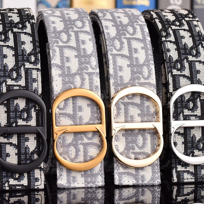 Four belts with different buckles on a reflective surface